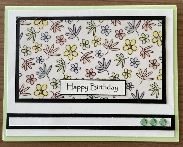 Happy Birthday card with multi-coloured hand drawn flowers.