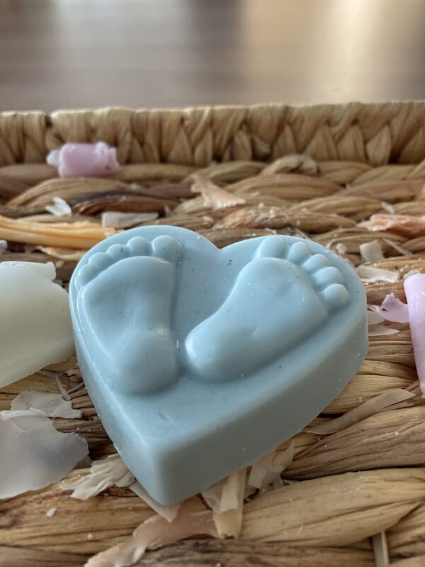 Blue heart shaped soap with feet on it