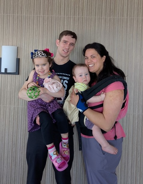 Smiling Family of a man, woman and two small children