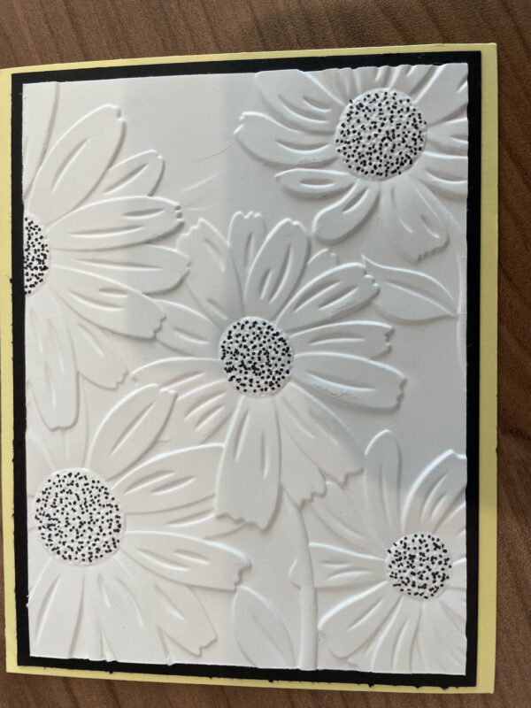 White card with flowers embossed on
