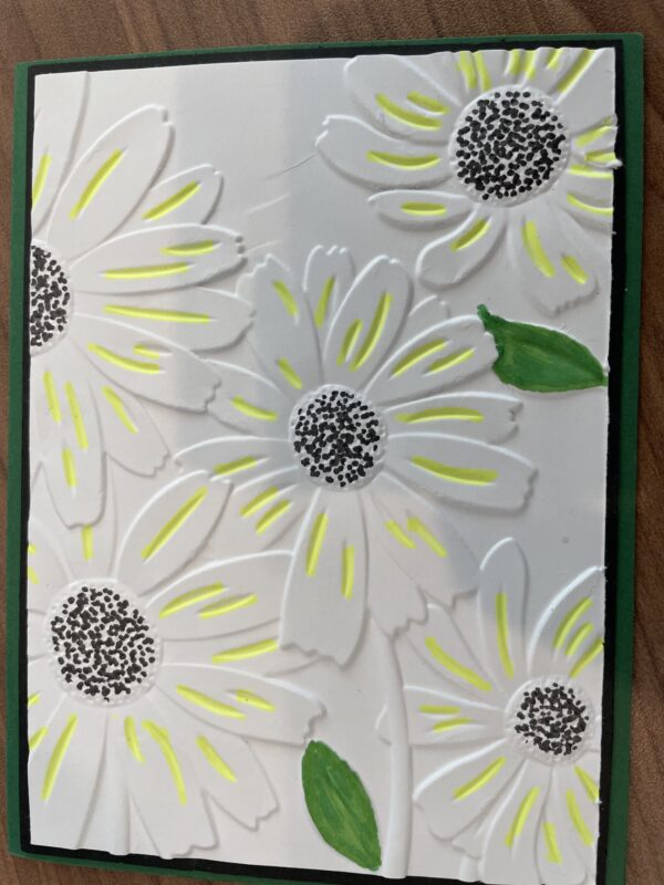Yellow petaled flowers on white embossed card