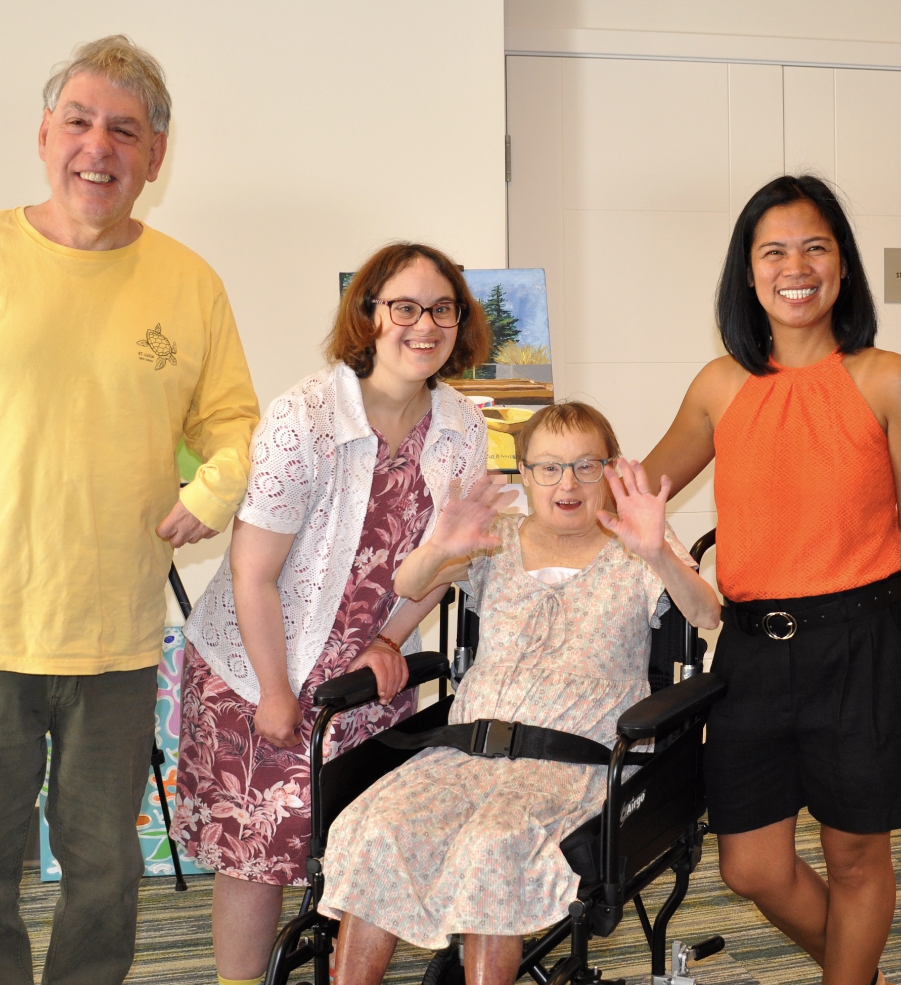 Group of 4 smiling and waving individuals Group of 4 smiling and waving individuals